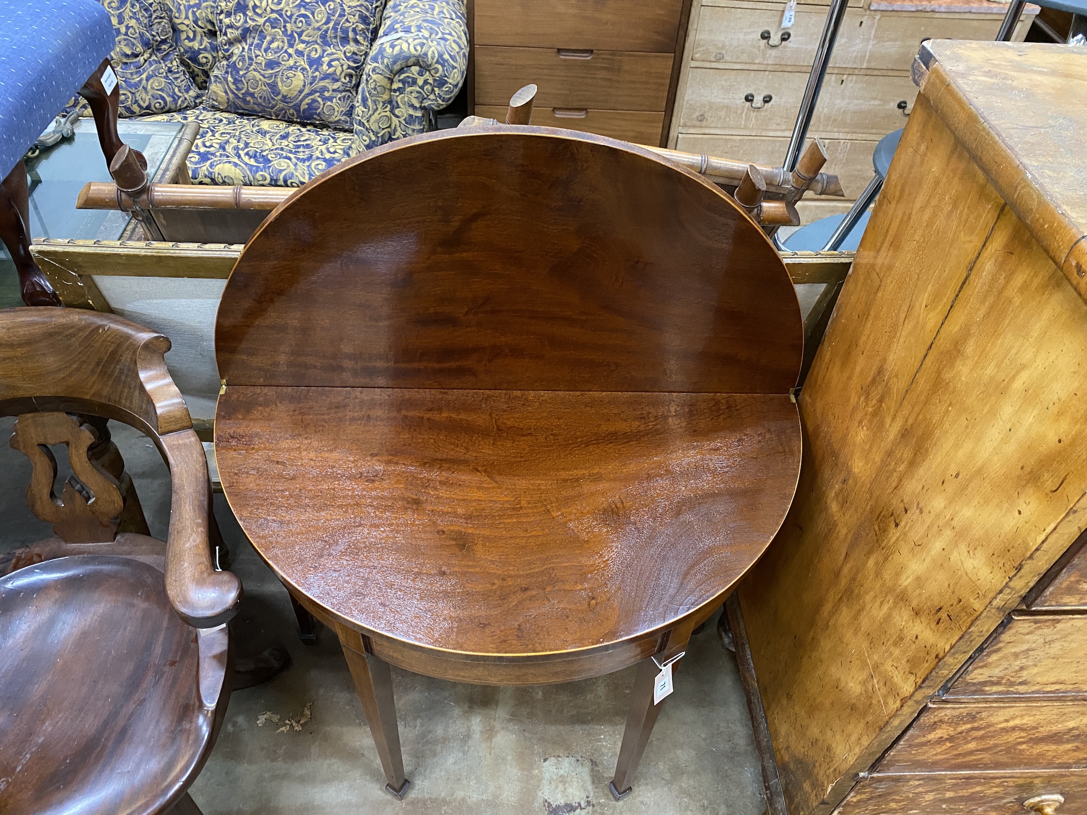 A George III mahogany demi-lune folding tea table, width 89cm, depth 44cm, height 74cm